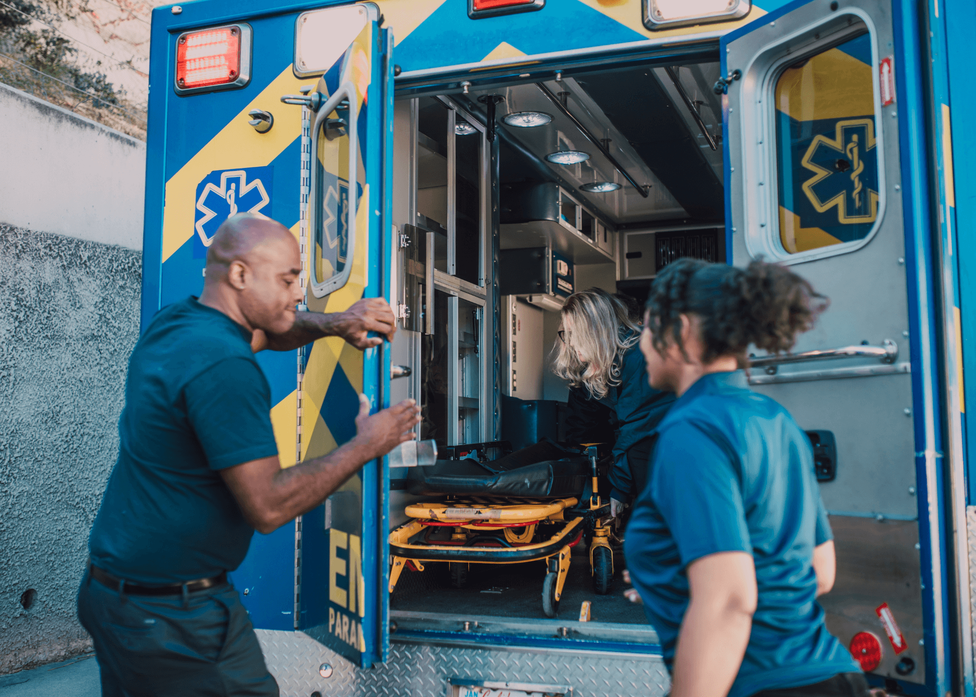 Paramedics standing outside an ambulance, prepared to provide emergency medical care.