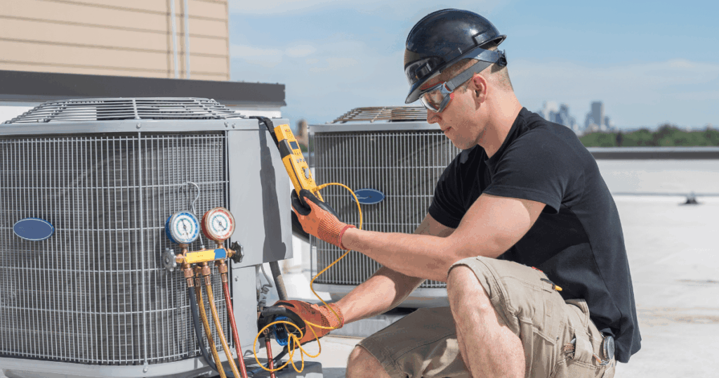 HVAC technician servicing rooftop commercial HVAC system to improve indoor air quality and system performance
